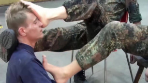 A lucky guy is allowed to lick the boots of German soldiers