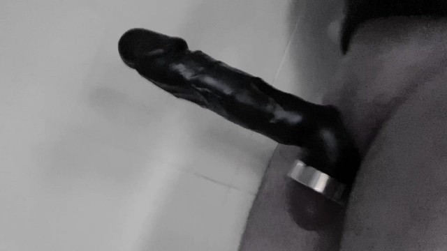 Playing with cock extension in bath