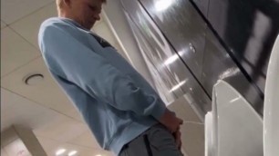 A male student is pissing in the toilet 8.
